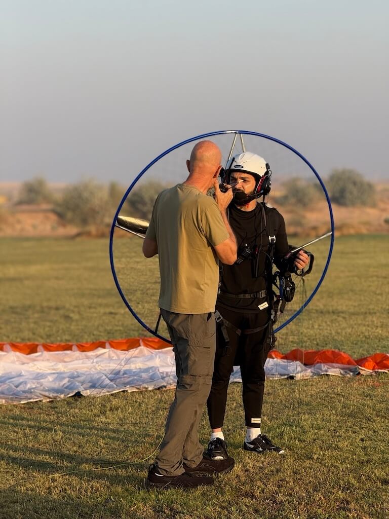 Standing ready for takeoff, getting last-minute instructions Salam Waddah preparing for paramotor take off